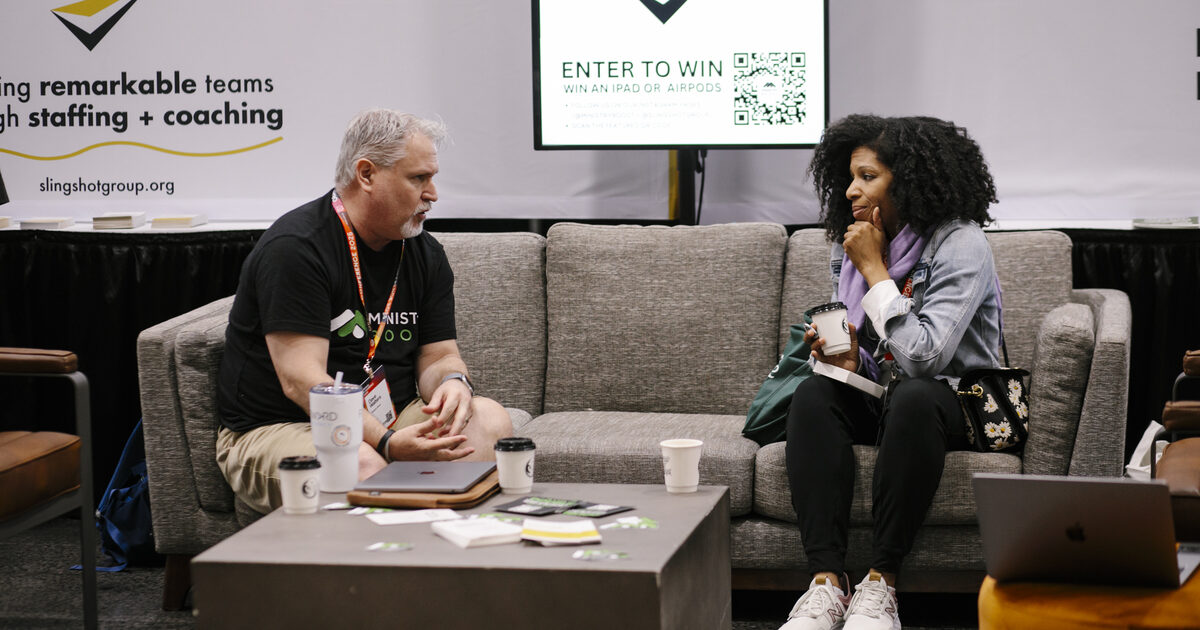 A ministry leader talking one-on-one with a volunteer about taking on a new responsibility