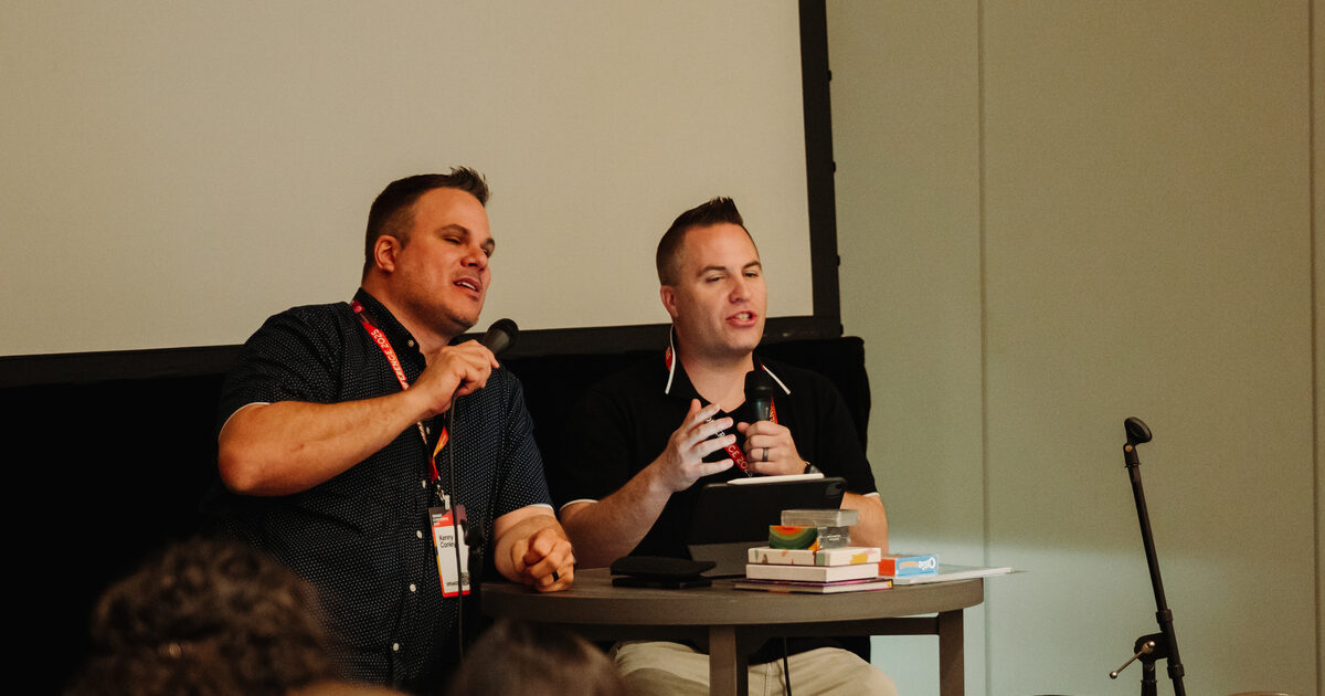 Two ministry leaders speaking together on a panel at a conference